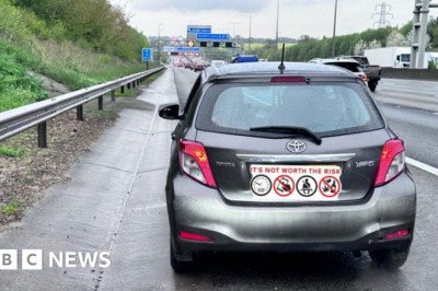 Car on M1 stopped with children sitting on passengers' laps