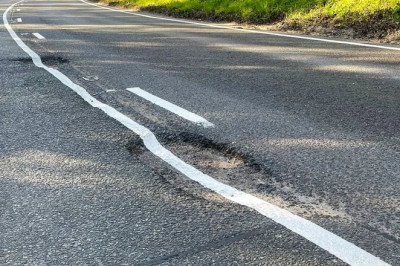 Hole lot of trouble! Council contractor paints white lines over large potholes BEFORE they were filled in