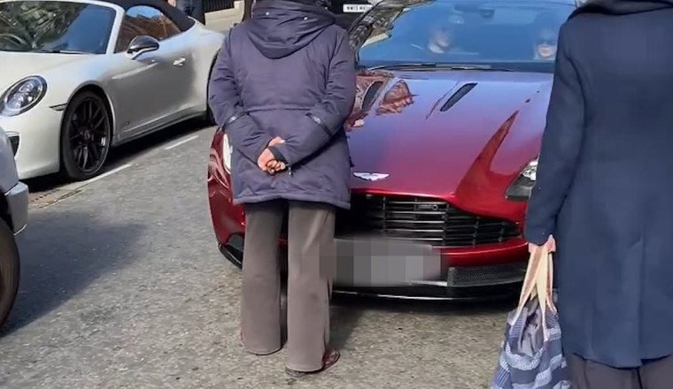 Moment furious woman walks into middle of the road in Mayfair to confront Aston Martin driver for revving too loudly