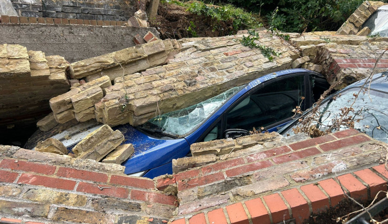 Used car dealership could be forced to shut after 12 vehicles are crushed by collapsed wall