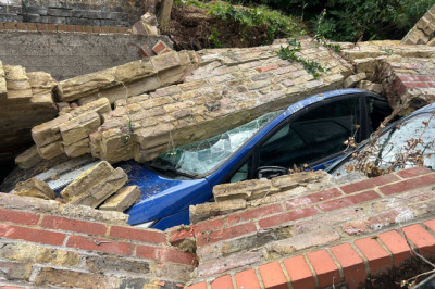 Used car dealership could be forced to shut after 12 vehicles are crushed by collapsed wall