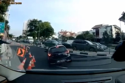 Horror as driver's car disappears dramatically into giant sinkhole