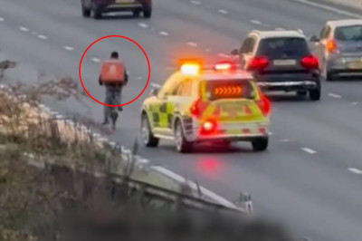 Moment delivery rider pedals along the M4 in rush hour traffic before officers pull him over