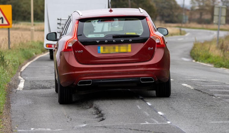 Furious motorists label pothole-ridden A-road as 'Britain's worst' after its 'dangerous' cracks and craters leave dozens of cars with flat tyres