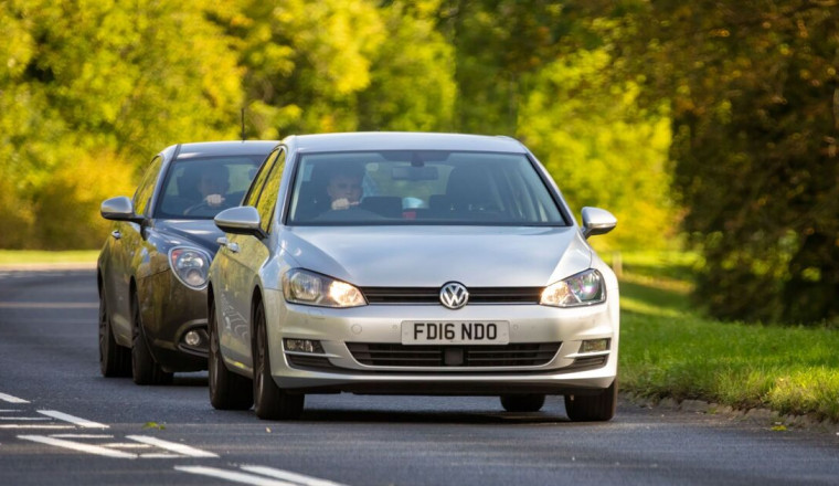 Woman driving on motorway has perfect response to tailgater without braking