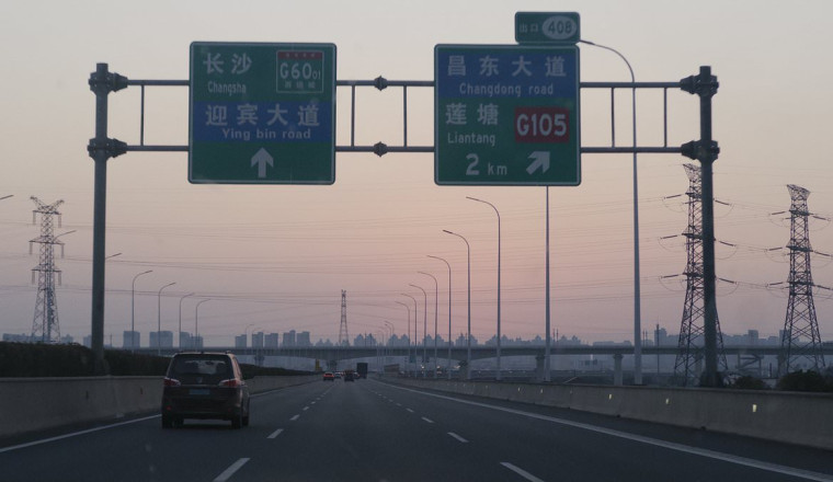 Here's what driving in China is really like - from anti-drowsiness lasers on motorways to temple toll booths