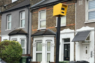 Frustrated residents put up fake speed camera to deal with speeding drivers on their road - only for council workers to remove it as it starts working