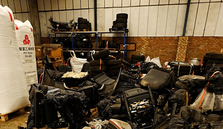 The stolen car graveyard: Inside huge warehouse packed with 'chop shop' vehicle parts that were intercepted by police before being shipped off across the world
