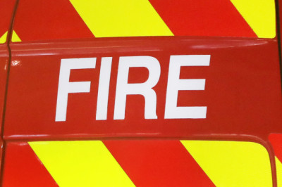 Major blaze rips through used car dealership as flames are seen billowing from building's roof