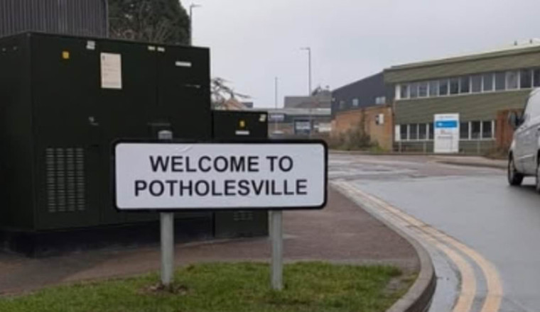 Road is so full of craters that residents rename it Potholesville... yet 'no authority will fix it'