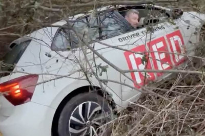 Moment drunken driving instructor is rumbled at the wheel of his test car - after police find him crashed into bushes in the middle of a ditch