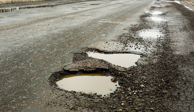Wet weather causes surge in crashes across Britain as drivers hit hidden potholes