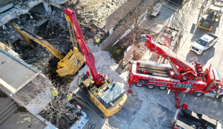 World’s Largest Rotator Tow Truck Called in After Excavator Falls Through Parking Garage
