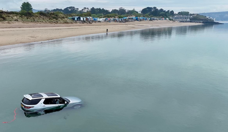 Driver's £80,000 luxury Land Rover gets completely submerged underwater in affluent Welsh beach resort dubbed 'Cheshire-on-Sea'