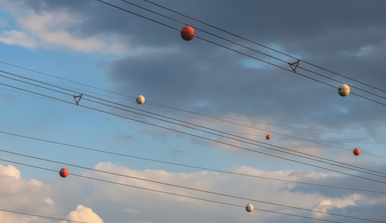 The Reason Power Lines Have Orange Balls Is Almost As Interesting As How They Get There